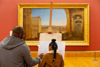 A man and a girl sketch in front of a painting