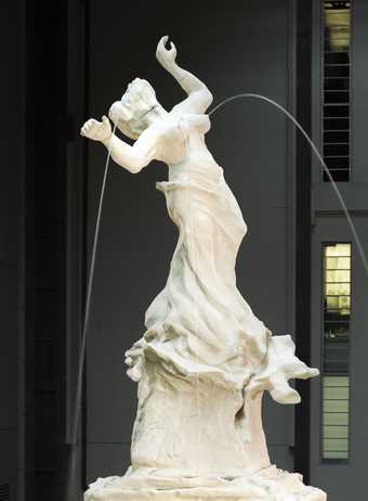 Installation by artist Kara Walker showing a water fountain coming from the breasts and neck of a figure