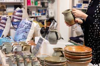 a person holds a jug in the shop