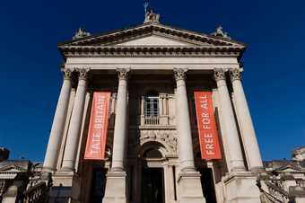 A large building with columns and banners that read 'Tate Britain and 'Free for all'