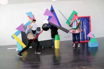 Kids posing with cutout shapes