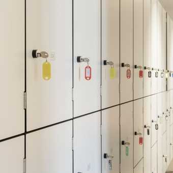 white lockers with keys in the doors.