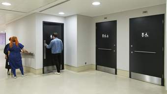 A corridor with three doors to toilets